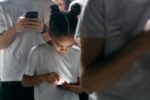 A child looking at a cell-phone