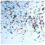 This image shows a pale blue sky with multicoloured confetti