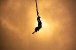 Bungee jump silhouette at sunset